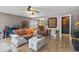 Cozy living room featuring hardwood floors, comfortable seating, and an open staircase at 11062 Gaylord St, Northglenn, CO 80233