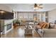 Open concept living room with hardwood floors, fireplace, and large windows offering ample natural light at 11062 Gaylord St, Northglenn, CO 80233