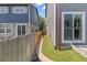 Side yard with artificial grass, wooden fence, and stepping stones at 11062 Gaylord St, Northglenn, CO 80233