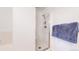 Clean bathroom with white tile, glass-enclosed shower, and ample towel storage at 2560 Concord Cir, Lafayette, CO 80026