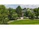 Lush property featuring mature trees and front yard with a white picket fence at 2560 Concord Cir, Lafayette, CO 80026