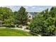 Lush property featuring mature trees and front yard with a white picket fence at 2560 Concord Cir, Lafayette, CO 80026
