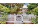 Charming home exterior with well-manicured landscaping and white picket fence at 2560 Concord Cir, Lafayette, CO 80026