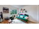 Cozy home office with a comfortable green futon and a natural-light-filled window at 2560 Concord Cir, Lafayette, CO 80026