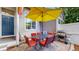 Cozy patio space with a dining table, chairs, grill, and a yellow umbrella at 2560 Concord Cir, Lafayette, CO 80026