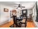 Bright dining area with fireplace, hardwood floors, and kitchen view at 2612 Meadowbrook Dr, Denver, CO 80221