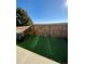 Landscaped backyard with artificial turf and a wooden fence at 17437 E Rice Cir # B, Aurora, CO 80015