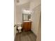 Bathroom with wood vanity, updated flooring and toilet at 17437 E Rice Cir # B, Aurora, CO 80015