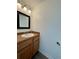 Clean bathroom with wood vanity and updated fixtures at 17437 E Rice Cir # B, Aurora, CO 80015