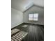 Well-lit bedroom with gray flooring, a large window, and a skylight at 17437 E Rice Cir # B, Aurora, CO 80015