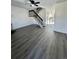 Living room with gray vinyl flooring, a fireplace, and a staircase at 17437 E Rice Cir # B, Aurora, CO 80015