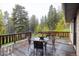 Well-maintained wooden back deck, ideal for relaxing and enjoying the serene wooded views at 1194 Camp Eden Rd, Golden, CO 80403