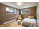 Bedroom with a window, comfortable seating, and a cozy bed creating a serene space at 1194 Camp Eden Rd, Golden, CO 80403