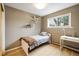 Cozy bedroom with natural light, showcasing a single bed, a desk, and decorative shelves for a warm, inviting feel at 1194 Camp Eden Rd, Golden, CO 80403