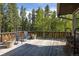 Spacious wooden deck with views of surrounding lush green trees at 1194 Camp Eden Rd, Golden, CO 80403