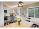 Eat-in kitchen featuring stainless appliances, a stylish light fixture, and outdoor views at 1194 Camp Eden Rd, Golden, CO 80403