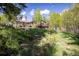 Charming home nestled on a grassy hillside with a spacious deck, perfect for enjoying the outdoors at 1194 Camp Eden Rd, Golden, CO 80403