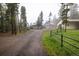 Serene exterior view of the property featuring a home, garage, and surrounding trees at 1194 Camp Eden Rd, Golden, CO 80403