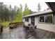Cozy outdoor deck with seating and flower pots, ideal for relaxing and enjoying nature's beauty at 1194 Camp Eden Rd, Golden, CO 80403