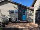 Charming home exterior with a bright blue door, complemented by a cozy deck and well-maintained landscaping at 1194 Camp Eden Rd, Golden, CO 80403