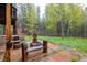 Outdoor fire pit area with seating surrounded by trees and a log cabin at 1194 Camp Eden Rd, Golden, CO 80403