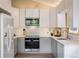 Modern kitchen with white cabinets, stainless steel appliances, sleek countertops, and a stylish backsplash at 1194 Camp Eden Rd, Golden, CO 80403