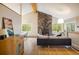 Spacious living room featuring a stone fireplace, hardwood floors, and ample natural light at 1194 Camp Eden Rd, Golden, CO 80403