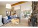 Open-concept living room features a stone fireplace and seamless access to dining area at 1194 Camp Eden Rd, Golden, CO 80403