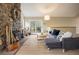 Comfortable living room with stone fireplace and sliding glass doors to the deck at 1194 Camp Eden Rd, Golden, CO 80403