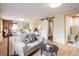 Spacious main bedroom with a seating area, large windows, and a sliding barn door leading to the ensuite bathroom at 1194 Camp Eden Rd, Golden, CO 80403