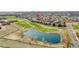 Beautiful aerial view of the neighborhood, golf course, and pond, showcasing the home's prime location at 11845 Mobile St, Commerce City, CO 80022