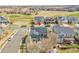 Aerial shot showcases the home with solar panels, landscaping, and neighborhood street appeal at 11845 Mobile St, Commerce City, CO 80022
