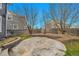 Spacious backyard with a rounded concrete patio area, rock garden, and privacy fence at 11845 Mobile St, Commerce City, CO 80022