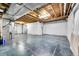 Unfinished basement featuring concrete floors, exposed beams, and white-wrapped walls at 11845 Mobile St, Commerce City, CO 80022
