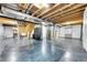 Unfinished basement featuring concrete floors, exposed beams, and utilities at 11845 Mobile St, Commerce City, CO 80022