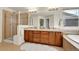 Bathroom featuring double vanity, soaking tub, and glass enclosed shower at 11845 Mobile St, Commerce City, CO 80022