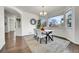 Dining room with hardwood floors, large window, contemporary table with chairs, and decorative plants at 11845 Mobile St, Commerce City, CO 80022