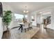Bright dining room featuring hardwood floors, a contemporary table with chairs, and a large window at 11845 Mobile St, Commerce City, CO 80022