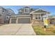 Attractive two-story house features a three-car garage, gray facade, and well-kept lawn at 11845 Mobile St, Commerce City, CO 80022