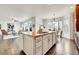 Kitchen island with granite countertop and views into living room and breakfast nook at 11845 Mobile St, Commerce City, CO 80022