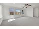 Spacious main bedroom with lots of windows and natural light, plush carpet and ceiling fan at 11845 Mobile St, Commerce City, CO 80022