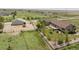 Aerial view of the home, barn, and fenced yard at 32501 E 137Th Way, Brighton, CO 80603
