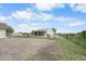 Exterior of horse barn features metal roof, fenced enclosure, and gravel area at 32501 E 137Th Way, Brighton, CO 80603