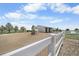 White barn with a fenced pasture on a property under a sunny, blue sky at 32501 E 137Th Way, Brighton, CO 80603