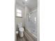 Bright bathroom featuring a glass shower enclosure, light wood-look floors, and a single window at 32501 E 137Th Way, Brighton, CO 80603