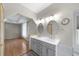 Bathroom with double vanity sinks, overhead lighting, and doorways that lead to a bedroom and toilet at 32501 E 137Th Way, Brighton, CO 80603
