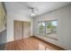 Bedroom with hardwood floors, large window with a view and closet with sliding wood doors at 32501 E 137Th Way, Brighton, CO 80603