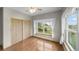 Bedroom featuring a large window, closet with sliding doors, and light-colored hardwood floors at 32501 E 137Th Way, Brighton, CO 80603