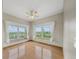 Sun-filled bedroom offering hardwood floors, ceiling fan, and two windows with white sheer curtains at 32501 E 137Th Way, Brighton, CO 80603