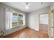 Sunlit bedroom with hardwood floors and a view of nature outside the window at 32501 E 137Th Way, Brighton, CO 80603